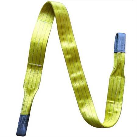 Flat sling and canvas lifting sling, flat woven webbing sling with an eye formed by stitching at each end, laid out in the workshop